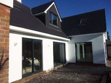 Mickle trafford , cheshire : Self Build project : Instaltion of "Allstyle" alumnium Sliding Patio doors and windows, dual coloured in grey outside white in. 
